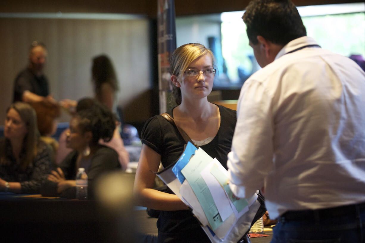 Cody Coss, 16, a Homelink student, listens to Ed Bush, an employment specialist with Goodwill, at a Youth Summer Job Fair in May at the Vancouver Community Library.