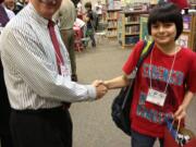 Washougal: Young Men in Action mentor Dave Bussman congratulates Hathaway Elementary School fifth grader Robert Noriega, a participant in the Camas-Washougal Rotary Club life skills program that wrapped up this month.