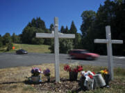 Traffic rolls past a memorial for Karey Brown and Steven Dodd on Northwest La Center Road near Northwest Eagle Crest Drive.