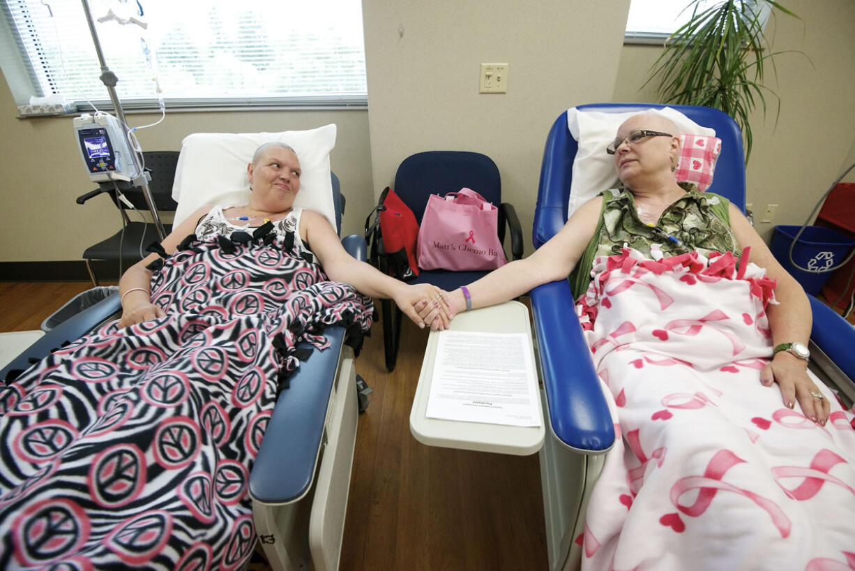 Crystal Alhilali, left, and her best friend, Linda Stief, undergo chemotherapy treatment Aug. 15 at The Vancouver Clinic in Vancouver.