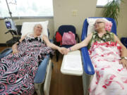 Crystal Alhilali, left, and her best friend, Linda Stief, undergo chemotherapy treatment Aug. 15 at The Vancouver Clinic in Vancouver.