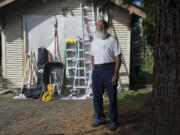 Jim Girard, chairman of the Arnada Neighborhood Association, stands Saturday with some of the equipment from the neighborhood tool-lending library.