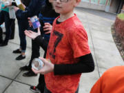 Battle Ground: Daybreak Middle School seventh-grader Colby Marsh helps move some of the in 3,851 pounds of food he and other Daybreak students collected for Battle Ground Public Schools&#039; annual holiday food drive, which brought in 23,928 pounds of food for the North County Food Bank.