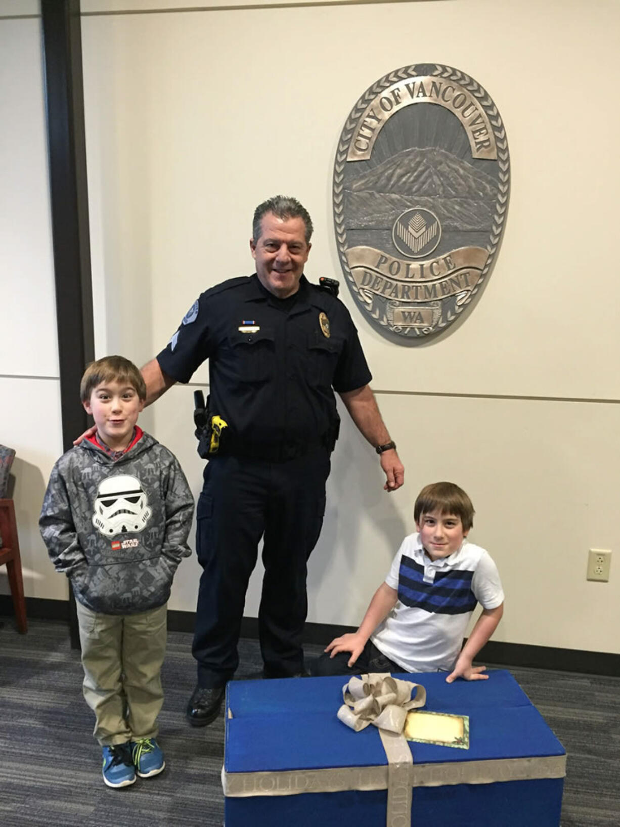 Hudson's Bay: Twins Luke and Matthew Bertrand with Vancouver Police Sgt. Mark Hochhalter on Dec. 22, when the two boys dropped off more than 200 St.