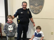 Hudson's Bay: Twins Luke and Matthew Bertrand with Vancouver Police Sgt. Mark Hochhalter on Dec. 22, when the two boys dropped off more than 200 St.