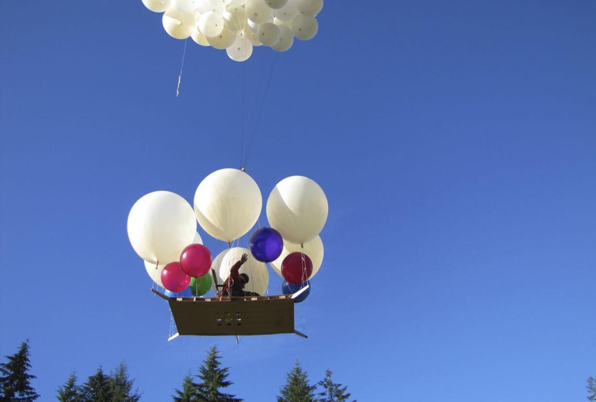 Lawn chair balloonist Joe Barbera lifts off from his home near Amboy, Saturday.