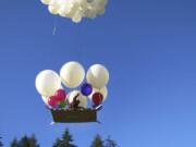 Lawn chair balloonist Joe Barbera lifts off from his home near Amboy, Saturday.