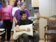 Joseph Reilly high-fives physical therapy assistant Shannon Nelson a day before he is to be released from the Fort Vancouver Convalescent Center.