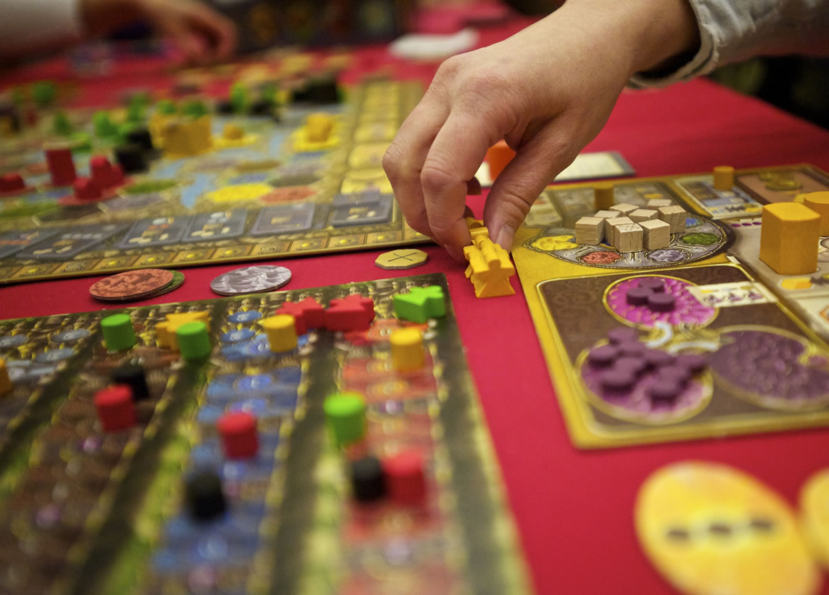 Sandy Stumpf of Seattle takes her turn at Terra Mystica with friends she just met at Gamestorm.