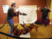 Brandon Suter, 25, of Eugene, Ore., watches the tower fall at the end of a game of giant Jenga with Keri Turner, 36, of Portland, in a hallway of the Hilton Vancouver Washington during Gamestorm.