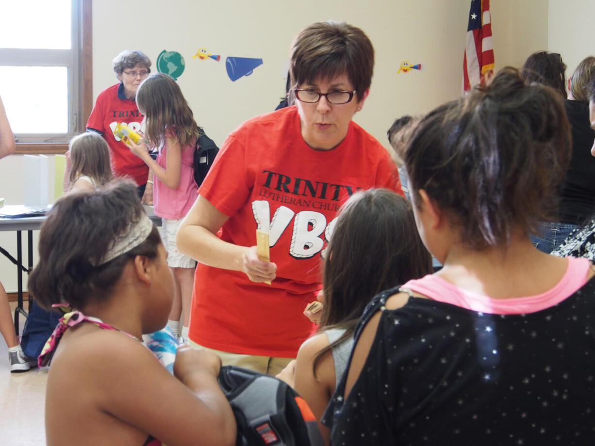 Lincoln: Susan Stevenson of Trinity Lutheran Church distributes school supplies to children.