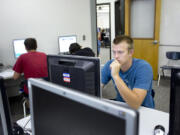 Alex Peterson, 16, a senior at Columbia River High School, works on the PLATO computer credit recovery program in summer school in an attempt to make up credits after failing classes as a Running Start student at Clark College.