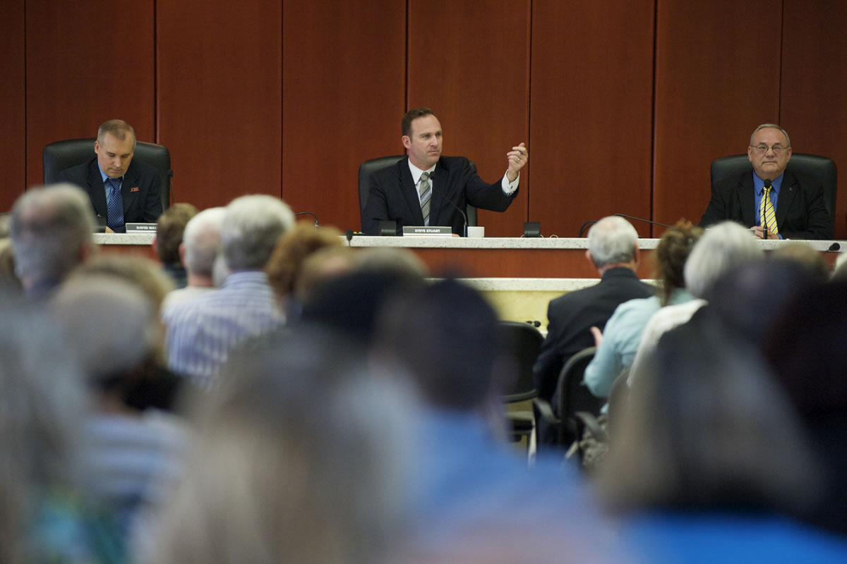 County commissioners David Madore, left, Steve Stuart, center, and Tom Mielke listened to more than 50 comments from the public Tuesday morning.