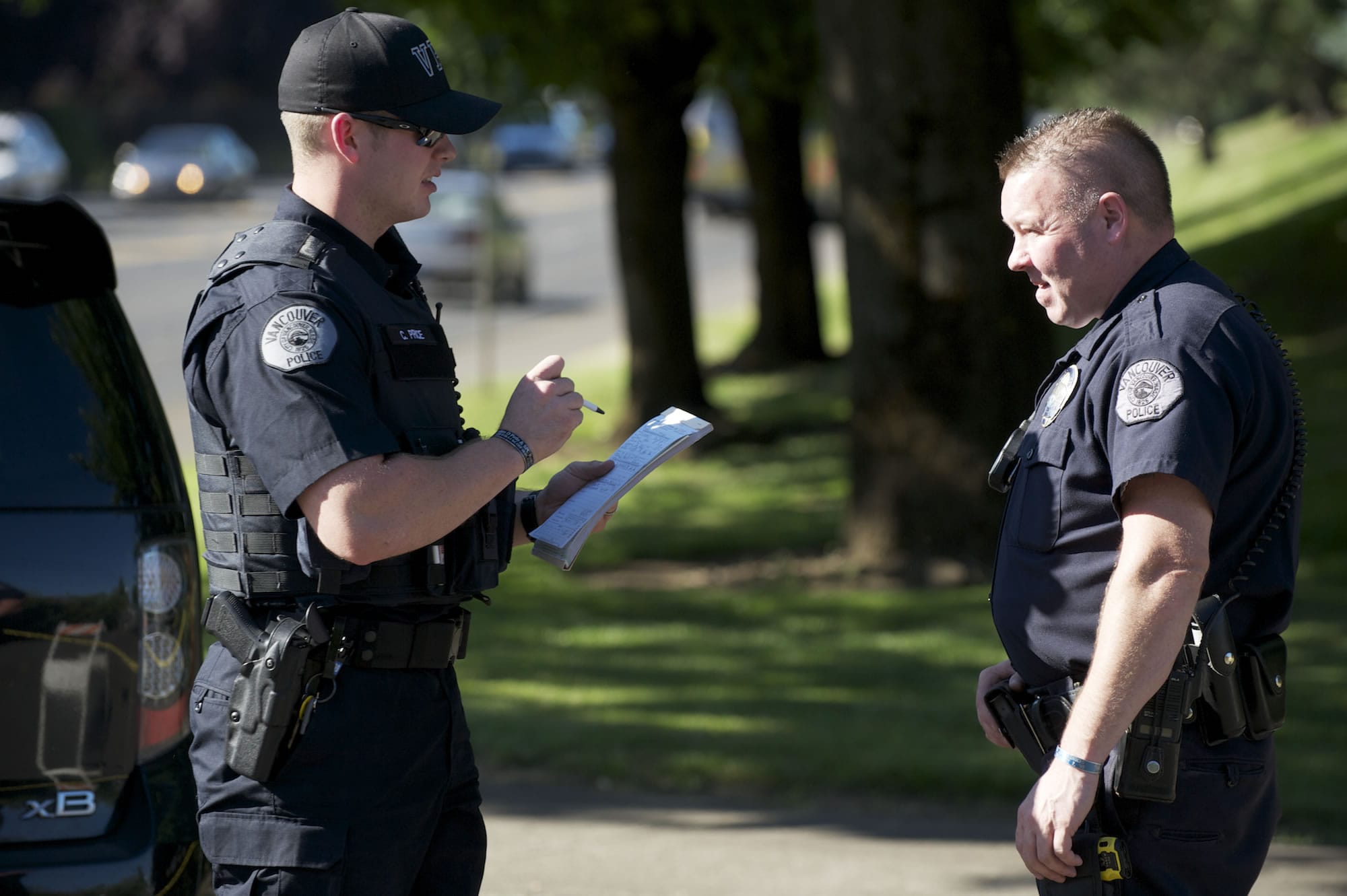 Price, left, learns from his field training officer, Sgt.