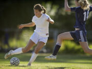 Easton Kawawaki, 6, left, of Columbia River High School takes a shot on goal in the second half against defender Michel Berry, 14, of Hockinson High School Tuesday in Vancouver.