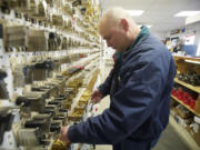 Kevin Bryan, owner of Curly's Lock &amp; Key Inc., makes a key for a customer.