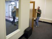 ITPro general manager Bob Berry, left, and tech manager Terry Meisner move furniture into the company's new office Monday.