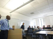 Bonneville Power Administration electrical engineer Ayo Idowu talks to a group of ninth-graders at Vancouver iTech Preparatory in October 2012 about a career in engineering with the BPA.