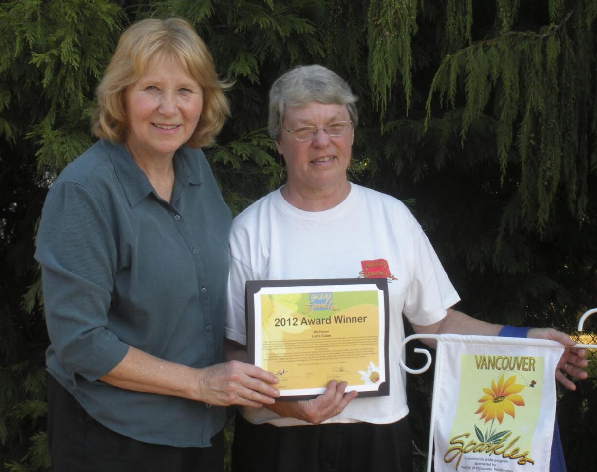 Shumway: Shumway Neighborhood Association Chairwoman Anne McEnerny-Ogle, left,  hands an award to resident  Linda Caton for her involvement in the neighborhood.