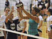 Misty May Treanor, right, assists Hanna Wyles from Battle Ground in a drill at her volleyball camp in Portland on Friday.