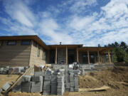 Work continues outside &quot;The Odyssey,&quot; one of four homes to be showcased starting Friday at the NW Natural Parade of Homes at Evergreen Pointe, a development near the Columbia River in Vancouver.