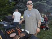 Jaime Manriquez, chairman of the Landover-Sharmel Neighborhood Association, grills food at a July 20 picnic.