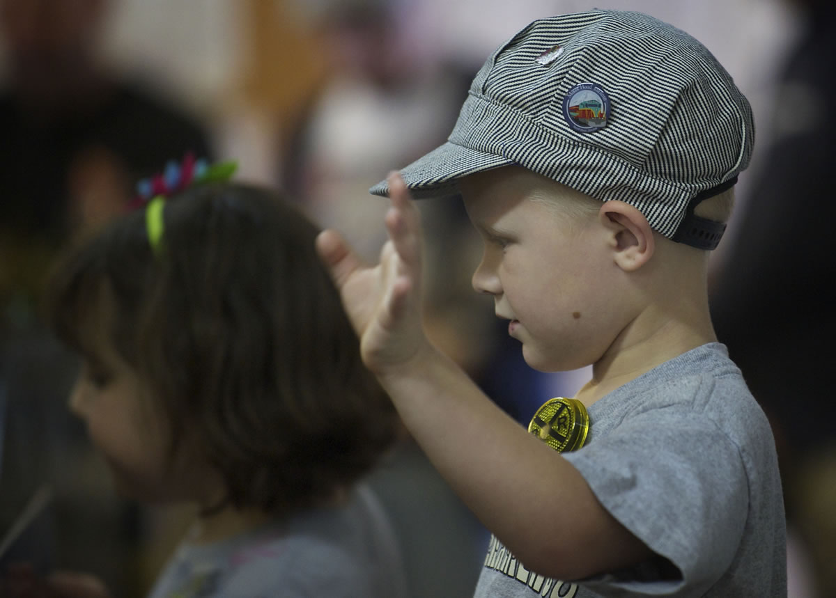 Zac Casanover, 4, waves at a passing train during the Southwest Washington Model Railroaders open house at their clubhouse on Saturday.