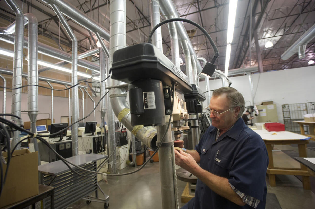 Photos by Steven Lane/The Columbian
Amfit, a manufacturer of custom orthotic shoe inserts and the machinery to make them, was able to remain healthy during the recession by expanding its overseas sales. Here, Glenn Chipman finishes an orthotic insert at Amfit.