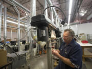 Photos by Steven Lane/The Columbian
Amfit, a manufacturer of custom orthotic shoe inserts and the machinery to make them, was able to remain healthy during the recession by expanding its overseas sales. Here, Glenn Chipman finishes an orthotic insert at Amfit.