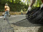 Construction crews are using a &quot;deep patch&quot; technique to rebuild the foundation under a section of Northwest Pacific Highway outside La Center.