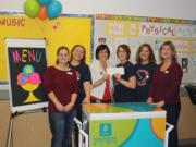 North Sifton: Amy Huff, from left, Ginny Gronwoldt, Dawn Harris, Carrie Torrance, Tami Eldredg and Lori Wick get a check for $2,000 from Umpqua Bank's Give Back to School Fund.