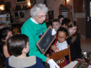 Washougal: Hathaway Elementary School students learn how small chalk boards were used at school in the &quot;olden days&quot; from Two Rivers Heritage Museum volunteer Cynthia Purdy.