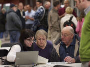 Landowners John and JoAnn Michel, center and right, look at an interactive map with Bonneville Power Administration consultant Katy Fulton during an open house meeting in Camas on Tuesday.