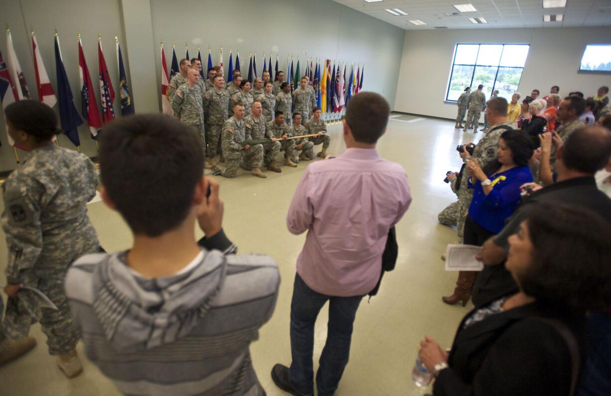 Members of the 915th Forward Surgical Team unit who will soon deploy to Afghanistan pose for pictures during the farewell ceremony at the Army Reserve Center on Saturday.