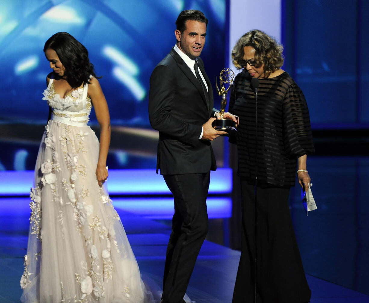 Bobby Cannavale, center, accepts the award for outstanding supporting actor in a drama series for his role on &quot;Boardwalk Empire&quot; as presenters Kerry Washington, left, and Diahann Carroll walk off stage at the 65th Primetime Emmy Awards at Nokia Theatre on Sunday in Los Angeles.