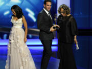 Bobby Cannavale, center, accepts the award for outstanding supporting actor in a drama series for his role on &quot;Boardwalk Empire&quot; as presenters Kerry Washington, left, and Diahann Carroll walk off stage at the 65th Primetime Emmy Awards at Nokia Theatre on Sunday in Los Angeles.