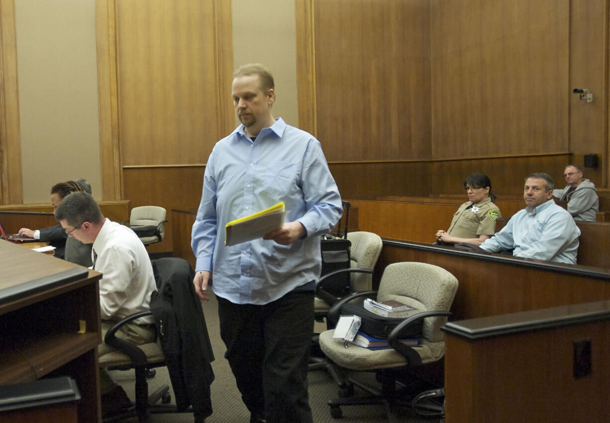 Pro se murder defendant Troy Fisher prepares to question witness Jennifer Norman during his murder trial in Clark County Superior Court Judge Barbara Johnson's courtroom today.