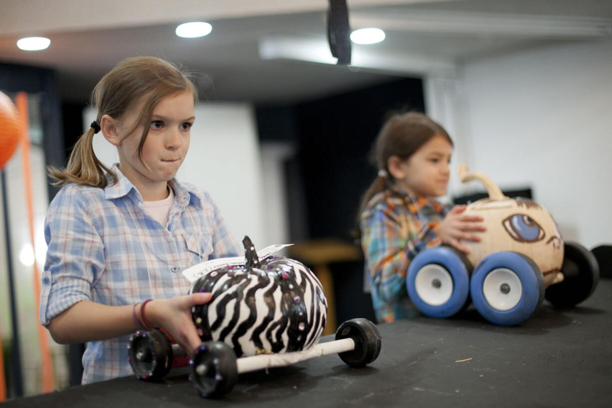 Torie Brockbank, 10, prepares to race her pumpkin, called ZB, at the Screaming Pumpkin Derby.