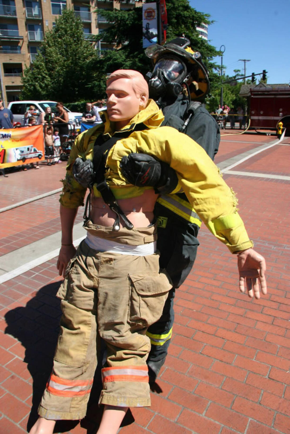 Esther Short: A local firefighter rehearses a rescue during the Fire in the Park skills competition and chili cook-off on July 20 at Esther Short Park.