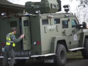 Clark County Sheriff's Cmdr. Tim Bieber shuts the rear doors of a Bearcat, an armored vehicle.