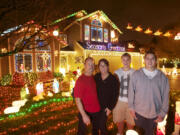 The Buchanan family, from left, Brad, Brenda, Brant, 15, and Bryce, 17, show off their Christmas light display.