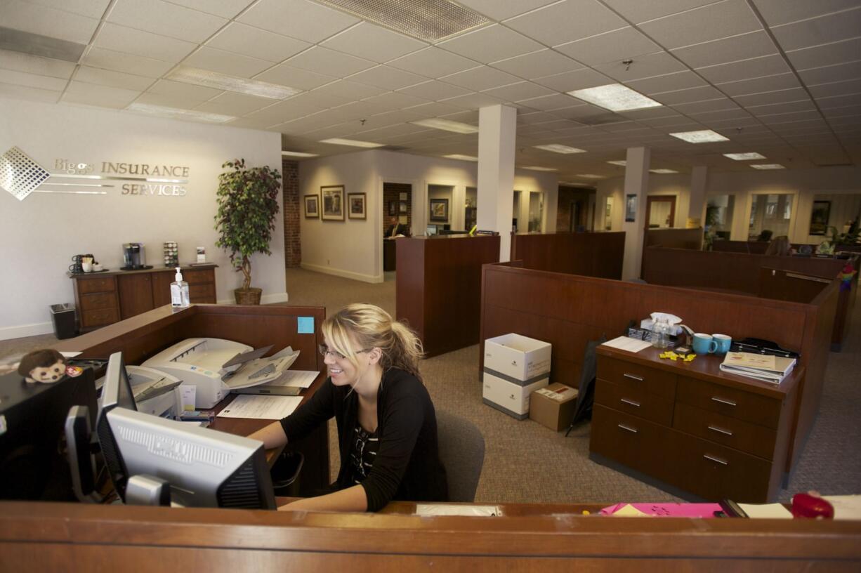 Receptionist Kelsi Deffenbaugh welcomes customers to Biggs Insurance Services in downtown Vancouver.