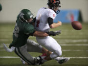 Skyline's Peyton Pelluer stops any hope of a Camas fourth quarter comeback after he forces a fumble by Camas quarterback Reilly Hennessey during a 4A semifinal match-up at the Tacoma Dome on Saturday November 24, 2012.