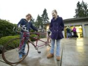 Harly and Courtney Forbes smile as they admire their new tandem bicycle given to them by Jackie and Richard Riordan on Tuesday in Vancouver. The Riordan's gave the bike to Harly and Courtney after their tandem bike was stolen the day before.