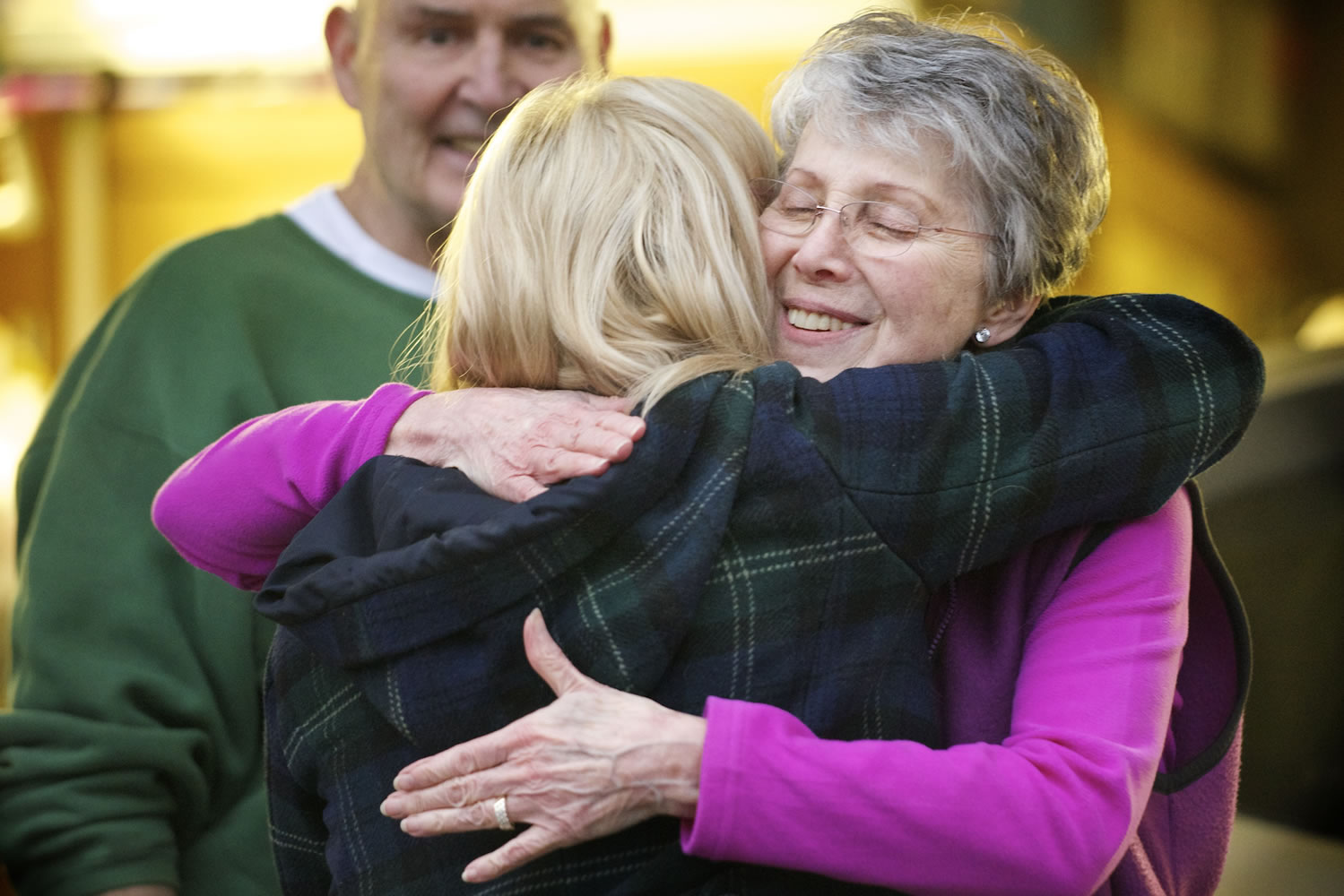 Kim Turner says thanks and goodbye as she is embraced by Jackie Riordan, while Richard Riordan, background, watches Tuesday in Vancouver. The Riordans gave their tandem bike to Harly and Courtney Forbes after their tandem bike was stolen the day before.