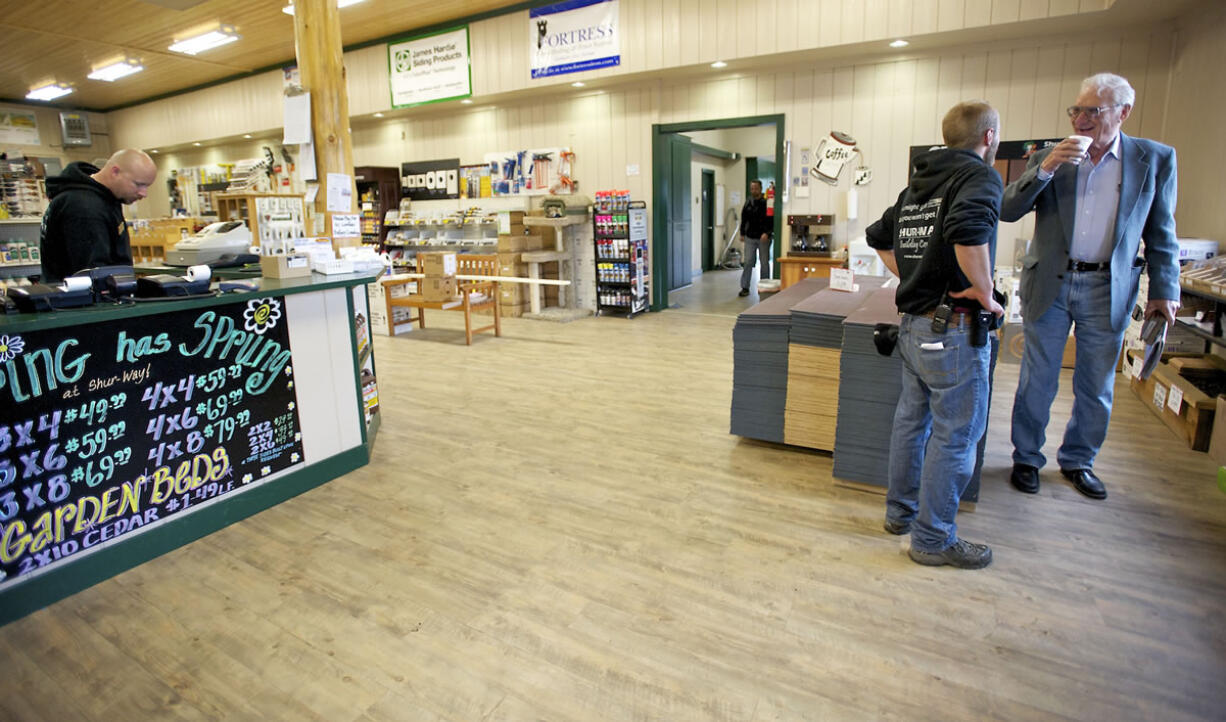 Shur-Way Building Centers salesman Brent Wilen, second from right, talks to David Vesowate of Ridgefield about composite decking materials.