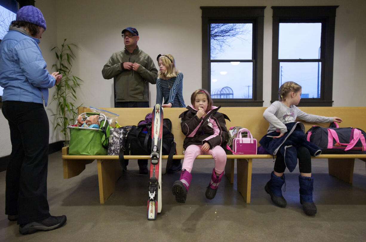 The Rylander family, from left, Suzy, Kurt, Truly, 12, Reese, 7, and Piper, 10, wait for the 5:07 Amtrak train to Whitefish, Mont., on Sunday.