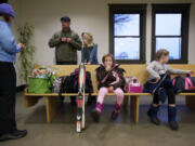 The Rylander family, from left, Suzy, Kurt, Truly, 12, Reese, 7, and Piper, 10, wait for the 5:07 Amtrak train to Whitefish, Mont., on Sunday.