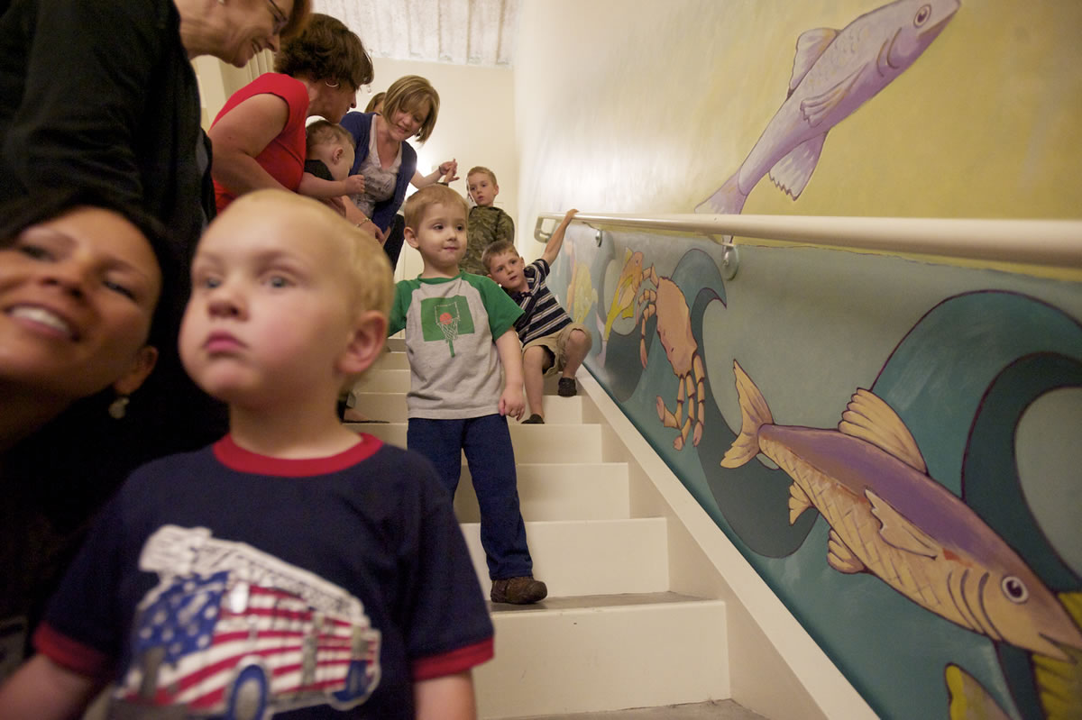 Photos by Steven Lane/The Columbian
Roman Kushniryuk, 4, center, said the crab was his favorite among the animals painted on the side of the stairwell where he does some of his physical therapy.