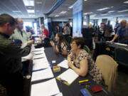 Tyson Jones, 37, left, from Vancouver, speaks with TMG's Director of Human Resources Sharon Jutila during a  jobs fair at the Red Lion at the Quay on May 23.